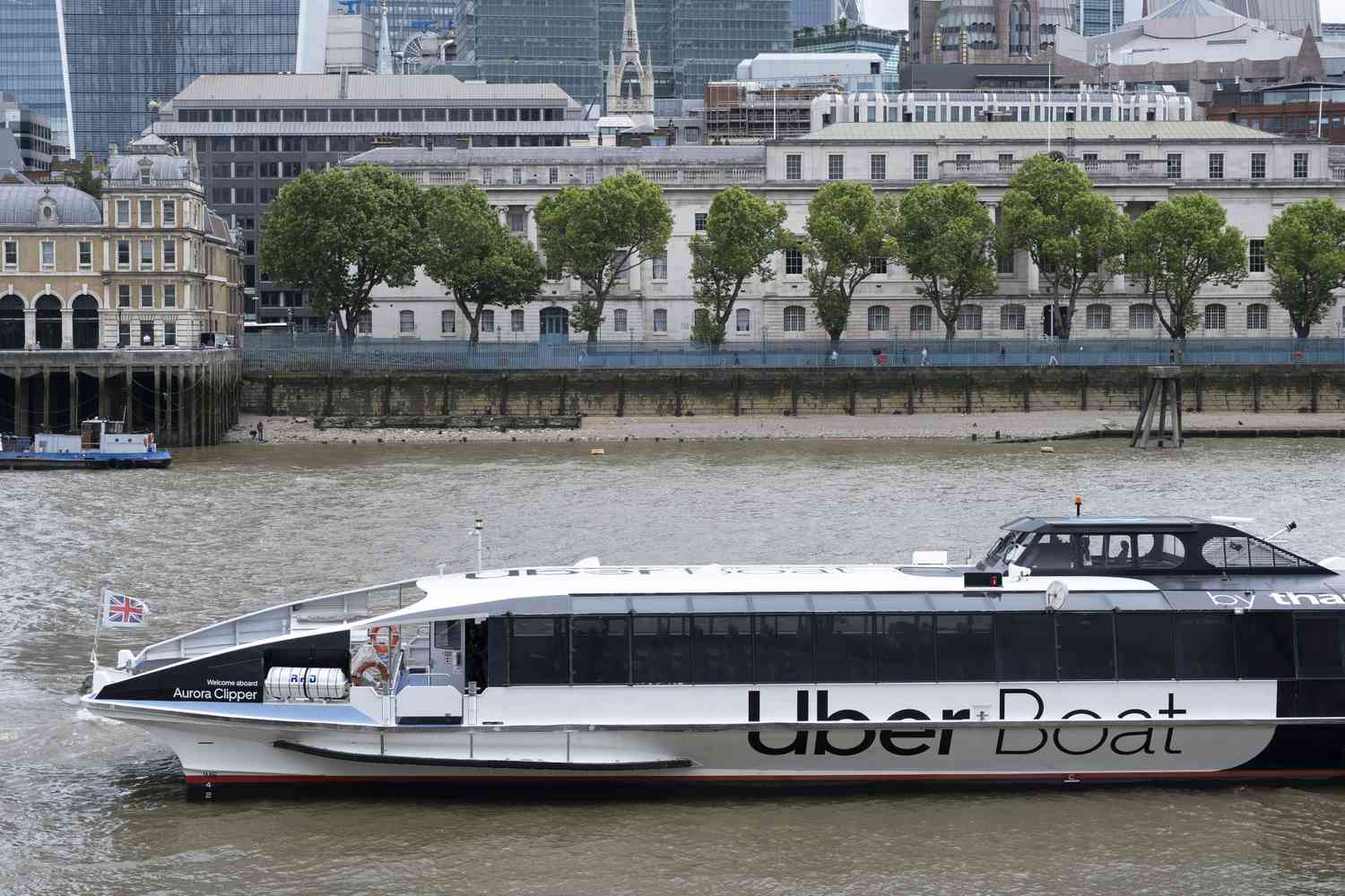 Uber Boat Thames Clipper passes the City of London on the River Thames from Bankside on 10th June 2024 in London, United Kingdom. 