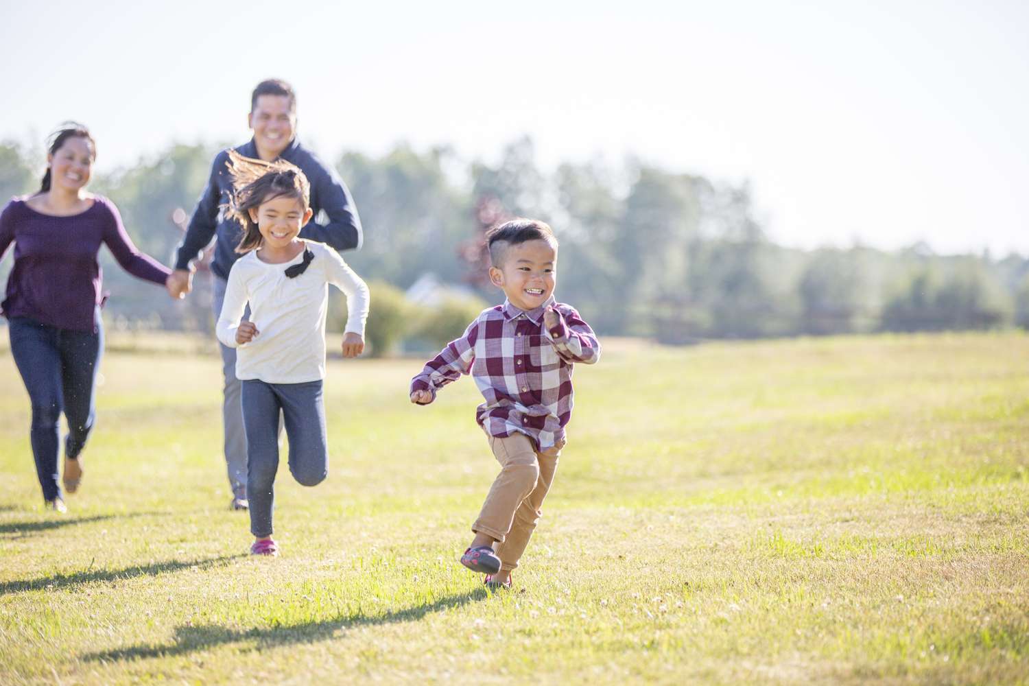 A family running through a field together.