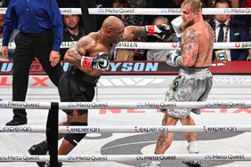  Mike Tyson, left, and Jake Paul during their boxing match on Friday in Arlington, Texas. 