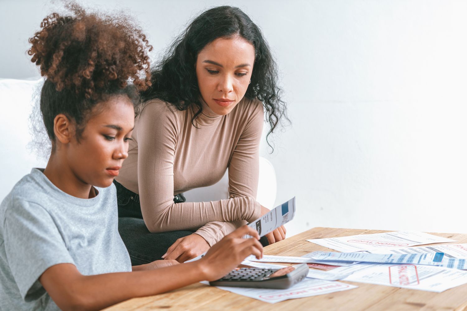 Mom teaching her daughter about finances.