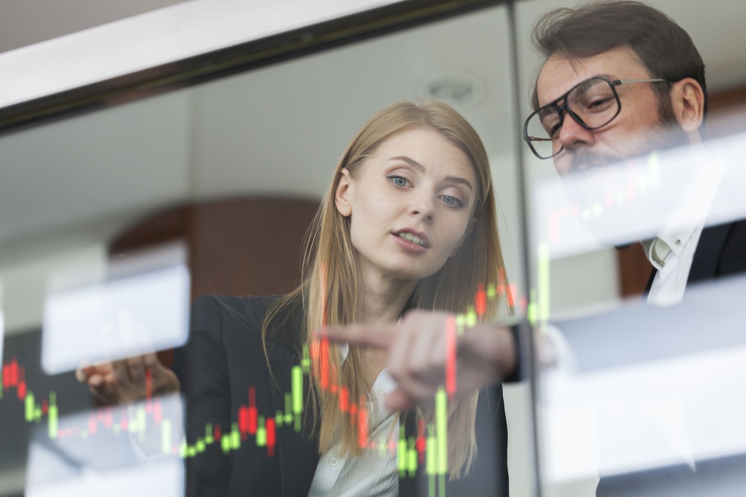Businesswoman and businessman talking profit on futuristic display.