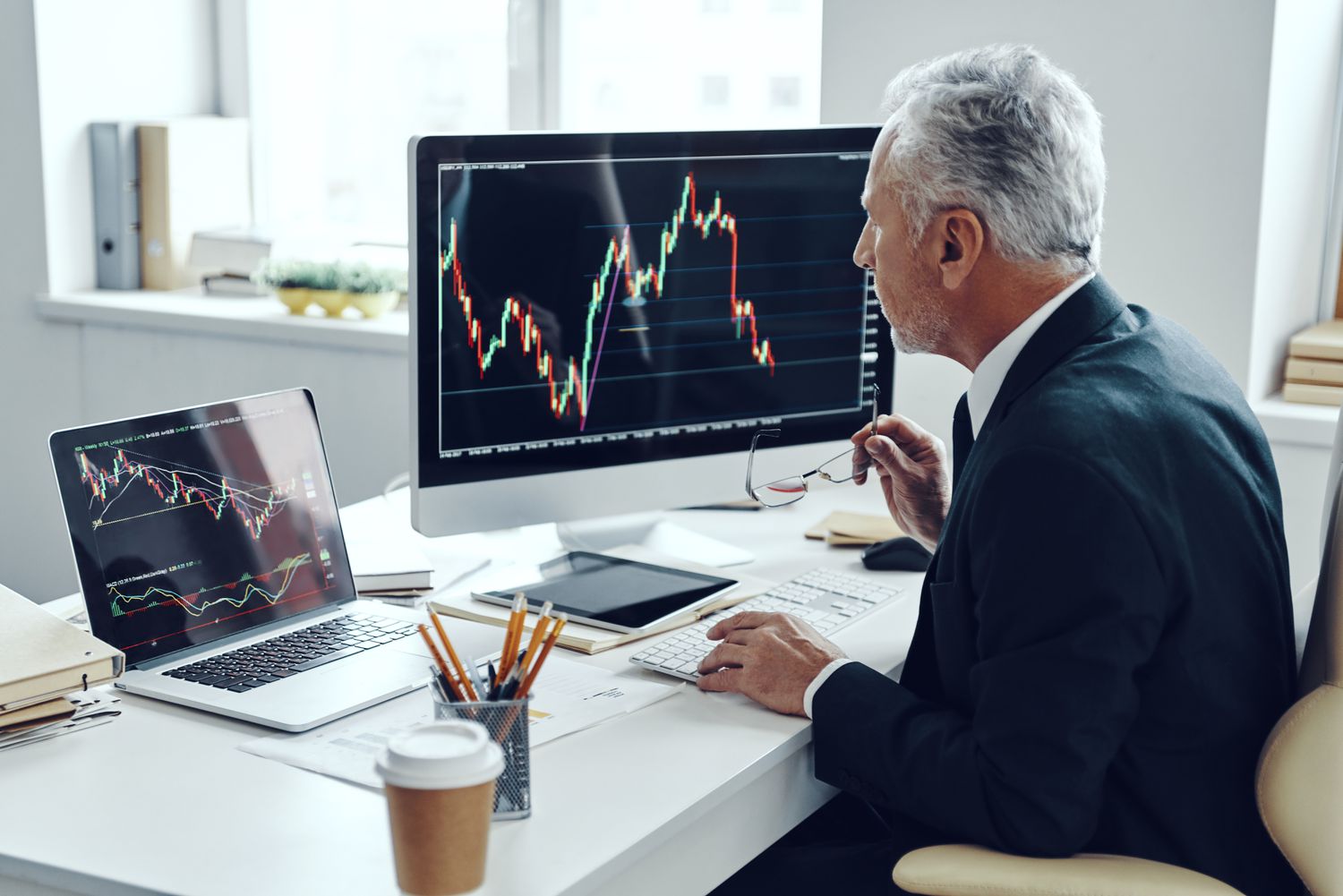 An experienced trader sits at a desk and uses computer charting to determine the volume-weighted average price of a security they follow.