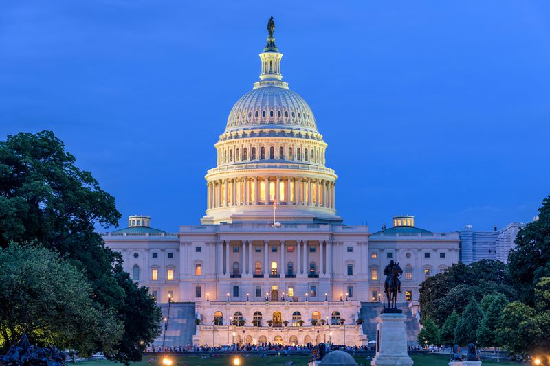 Summer Night at Capitol Hill - A dusk view of west-side of the U.S. Capitol Building, as a small crowd gathering around a summer concert at front, Washington, D.C., USA.