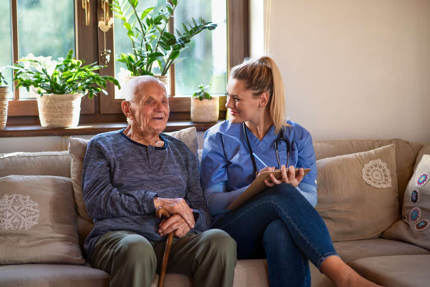Young female healthcare worker and senior man in a conversation