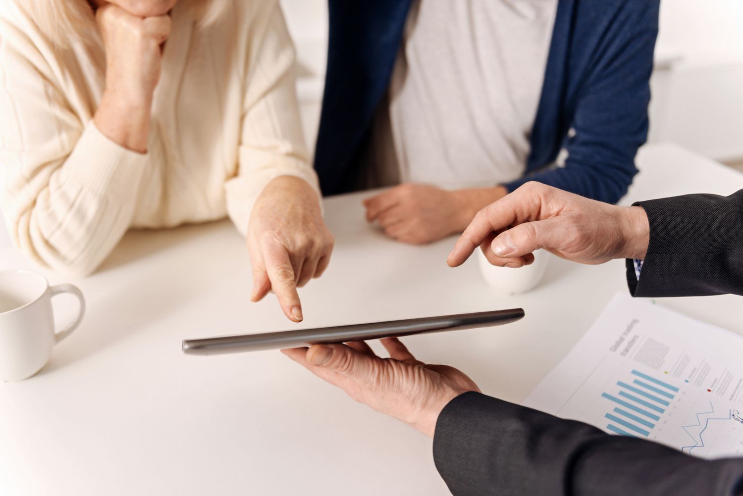 A lawyer helping a couple showing them a tablet.
