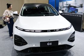 A visitor inspects a Chinese-manufactured Xpeng G6 electric car during ASEAN Sustainable Energy Week and Electric Vehicle Asia 2024 at Queen Sirikit National Convention Center in Bangkok, Thailand on July 5, 2024