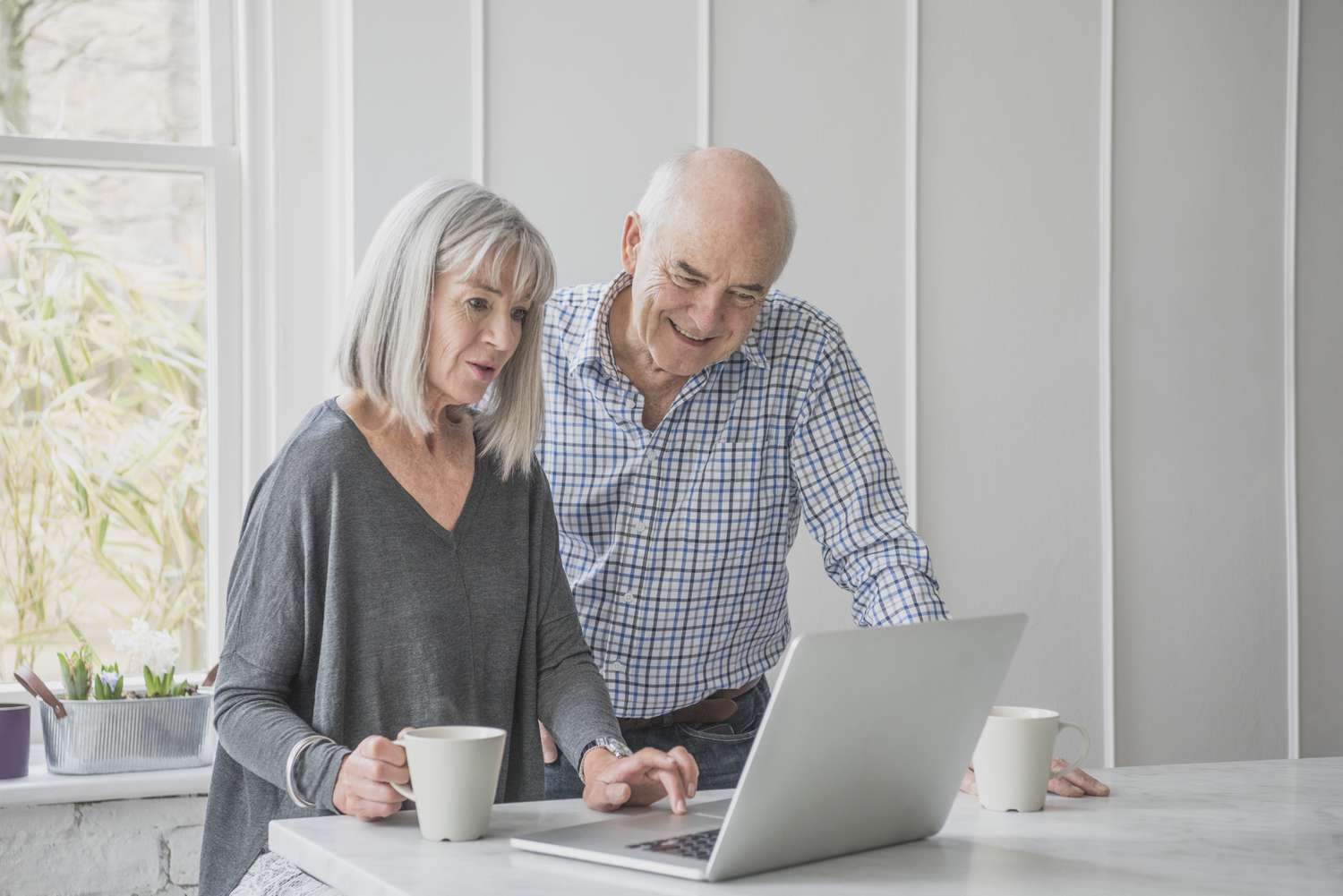 Elderly couple looking at laptop