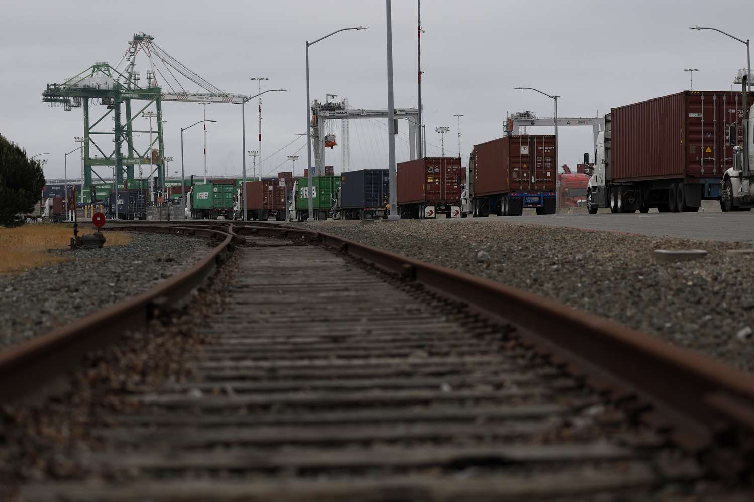 Trucks line up to enter a shipping berth at the Port of Oakland on April 18, 2025 in Oakland, California.