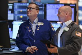 Traders work on the floor of the New York Stock Exchange.