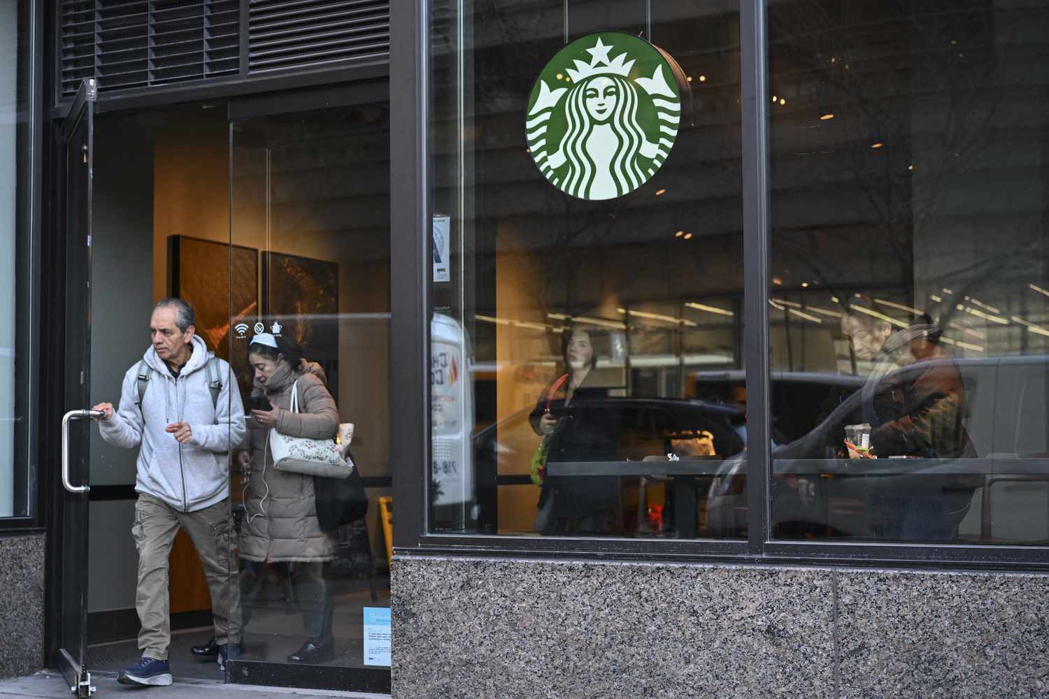 People leaving a Starbucks in New York City