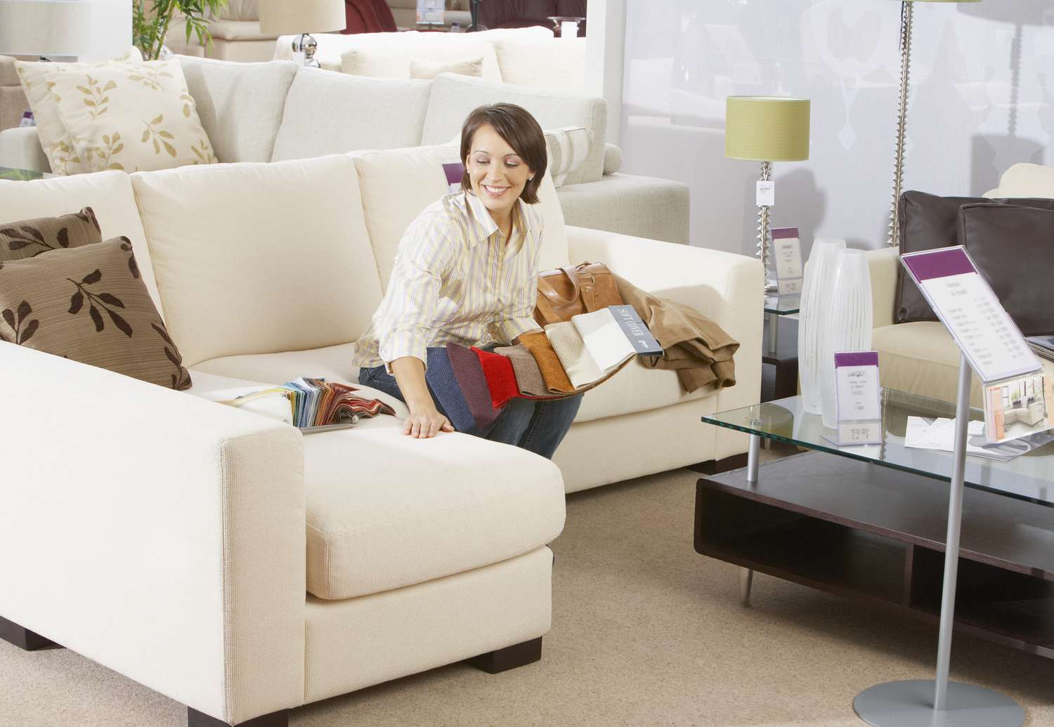 Woman looking at fabric swatches in a furniture store