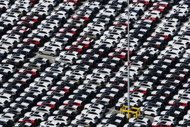 Rows of cars sit in a lot at the Port of Los Angeles.