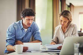 Couple going through their finances at home to find ways to rebuild their credit.