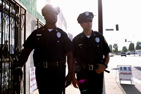 Two policemen walking down the sidewalk