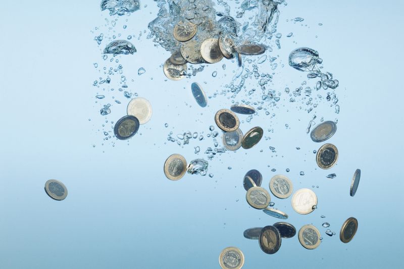 euro coins sinking in water