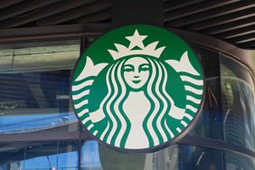 Close-up of a Starbucks logo on a building's facade.