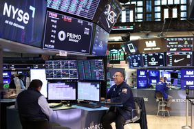 Traders work on the floor of the New York Stock Exchange