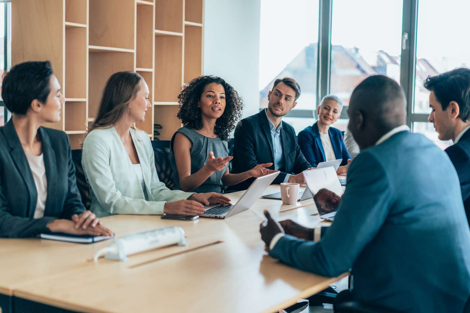 Business meeting at conference table discussing acquistion