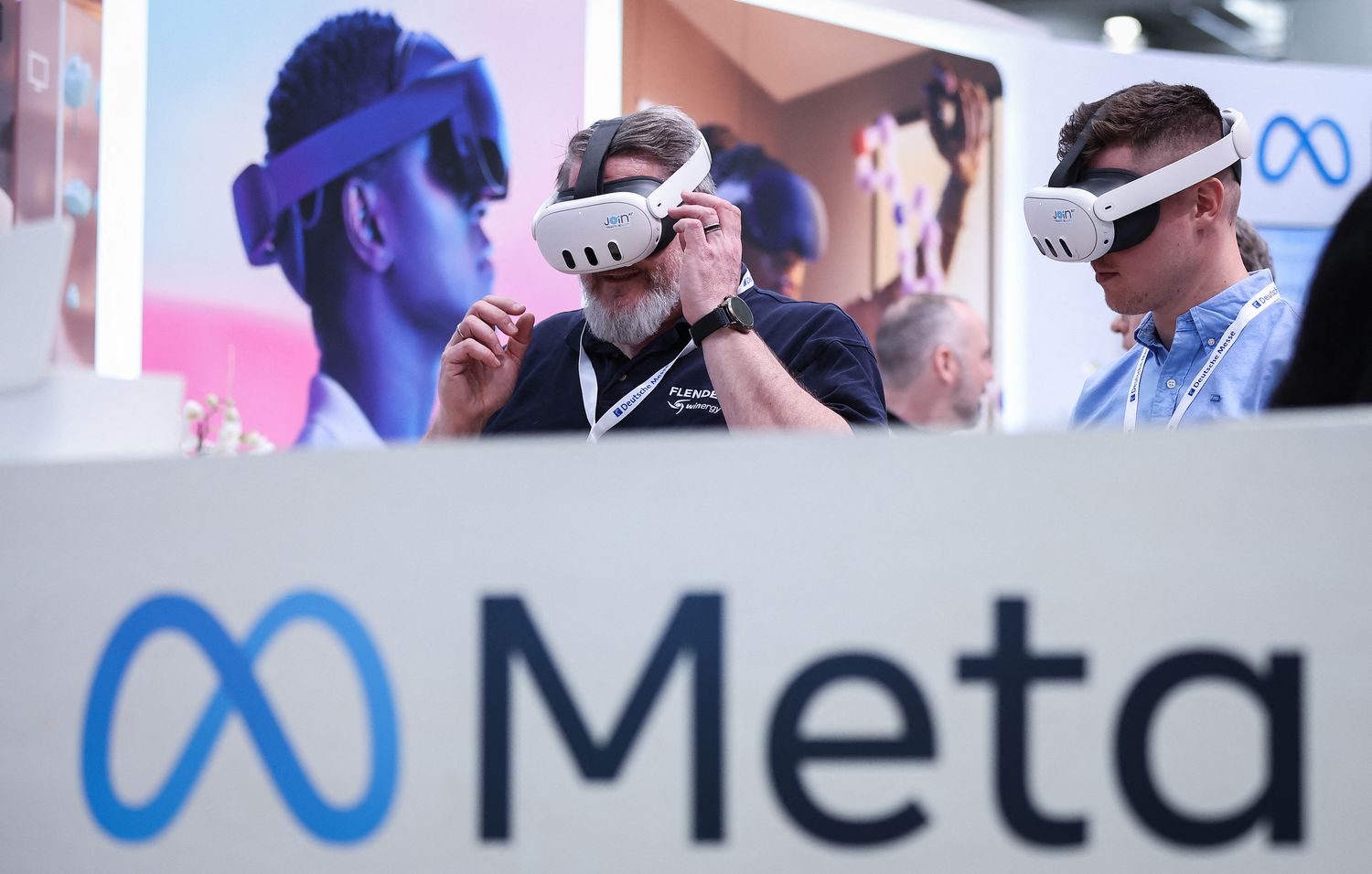 Visitors test Meta Quest 3 goggles at the booth of Meta Platforms at the Hanover technology Fair on April 22, 2024 in Hanover, northern Germany