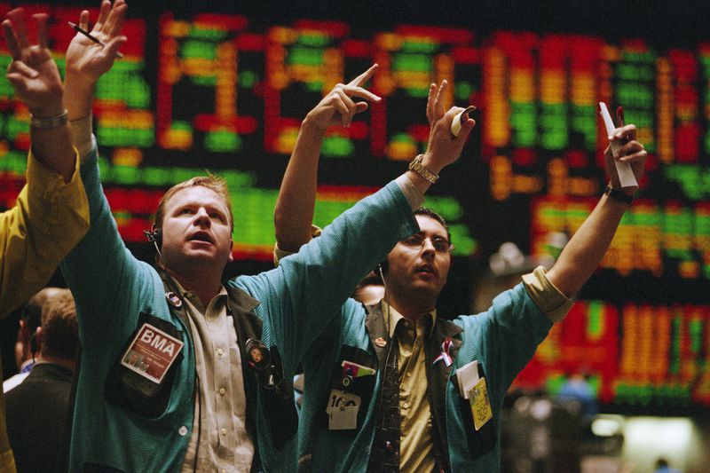 Traders signaling trades on a stock exchange floor