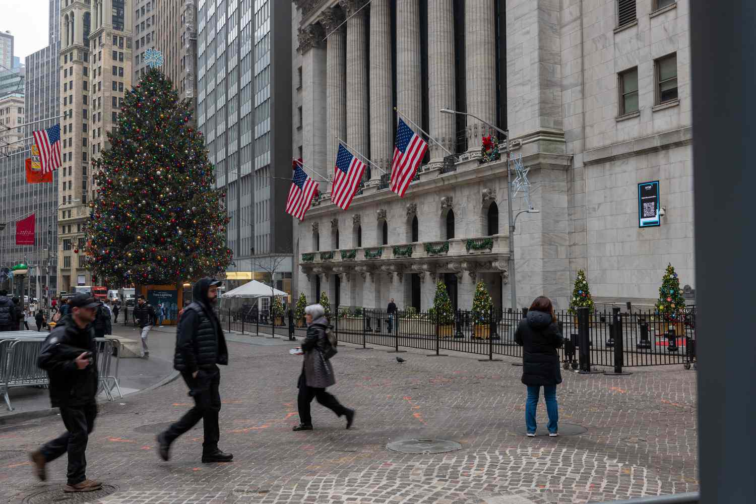People walk past the New York Stock Exchange on Dec. 26.