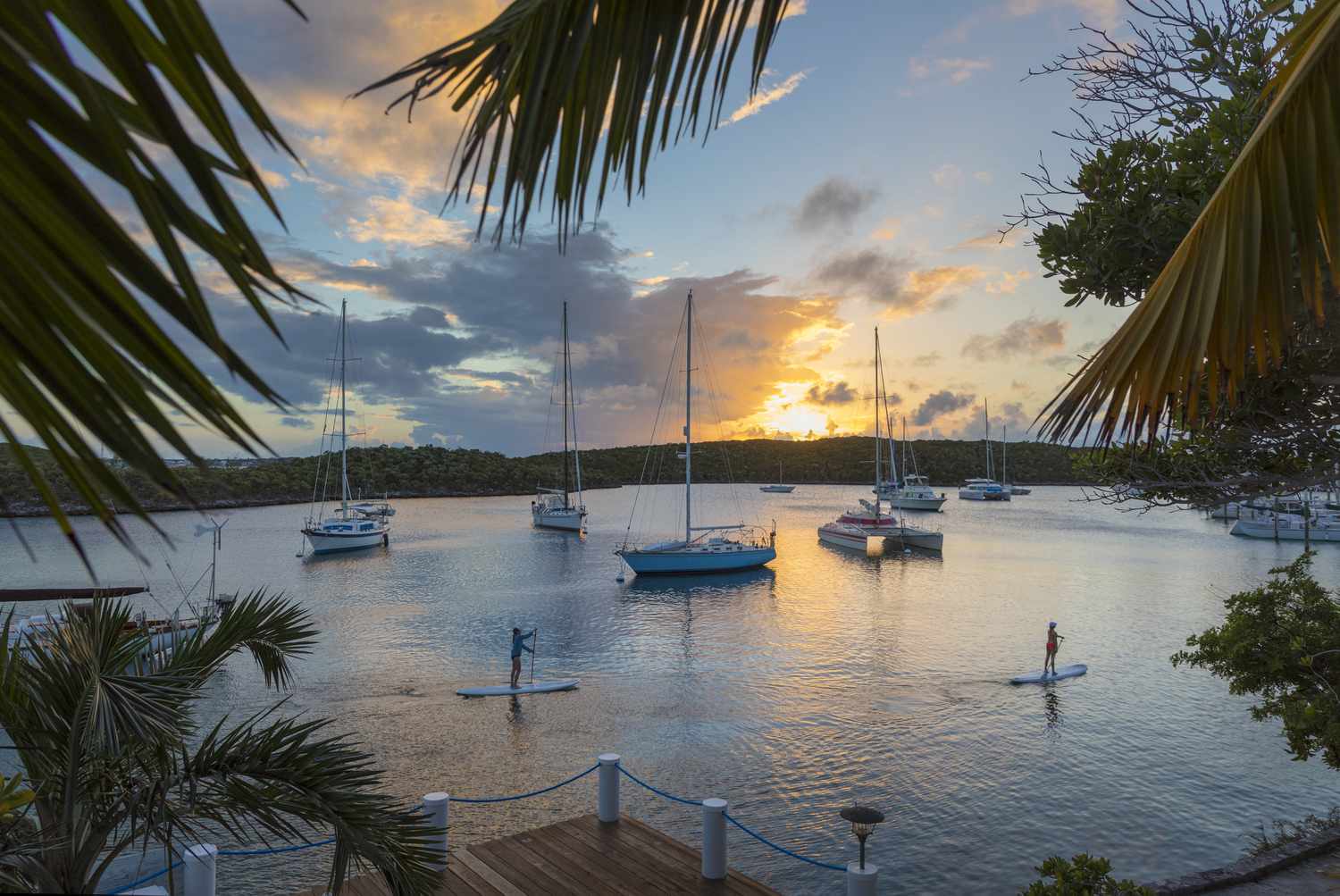 Two people paddle boarding at the Bahamas.