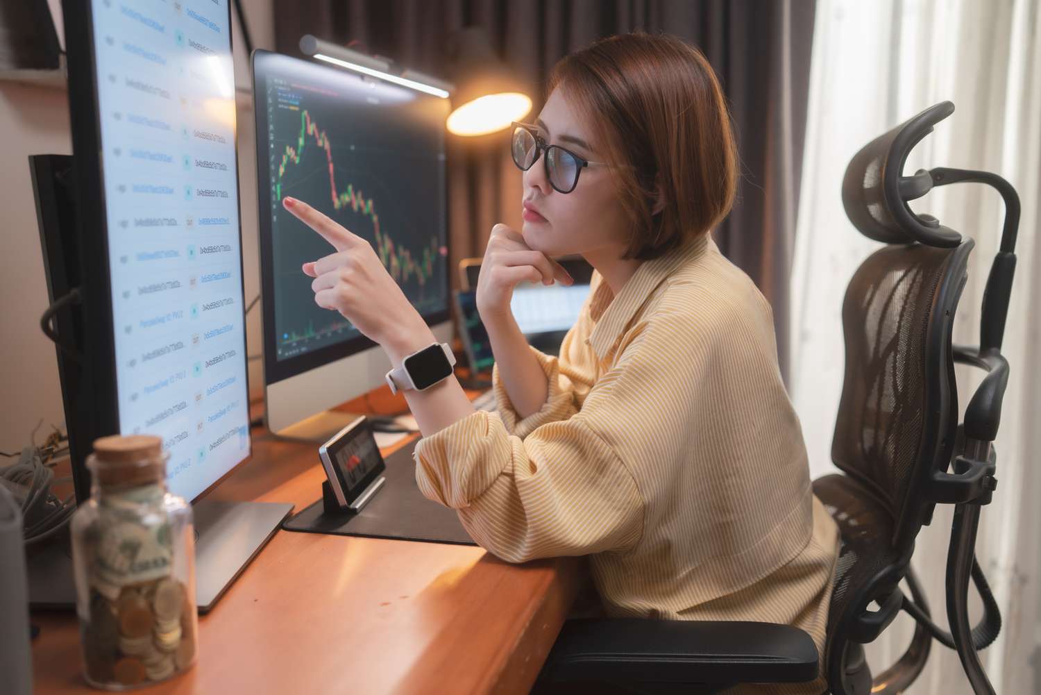 An investor studies a screen of stock data on a large monitor as they think about shorting a stock they hold.