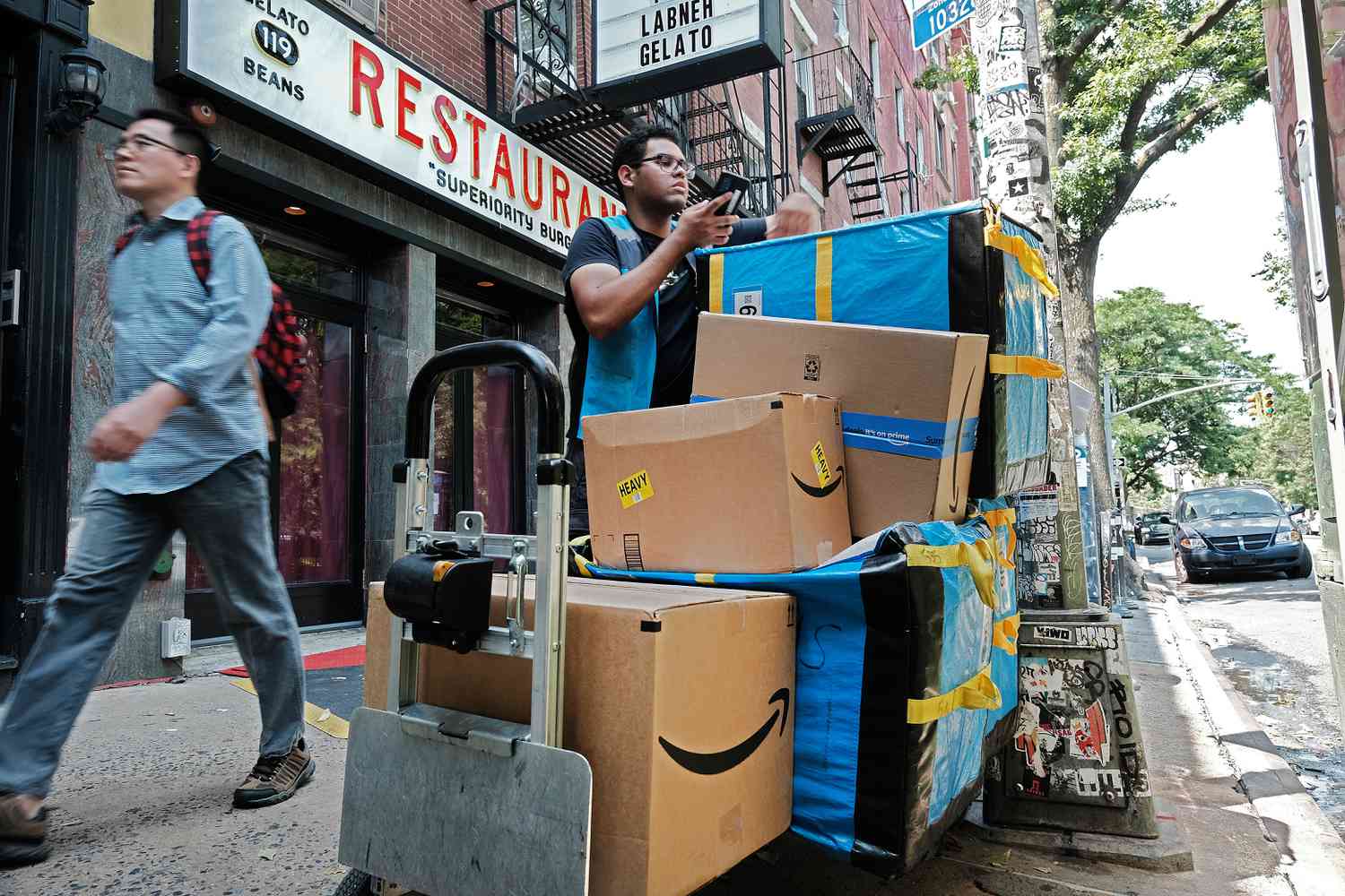 An Amazon worker moves boxes on Amazon Prime Day on July 11, 2023, in the East Village of New York City.