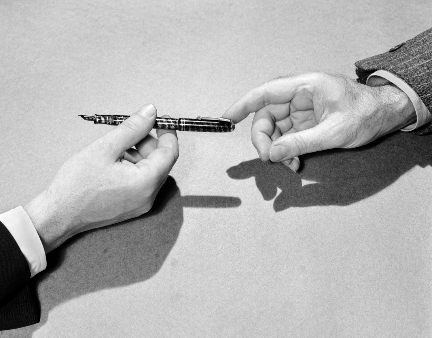 Businessmen pass a fountain pen, 1939