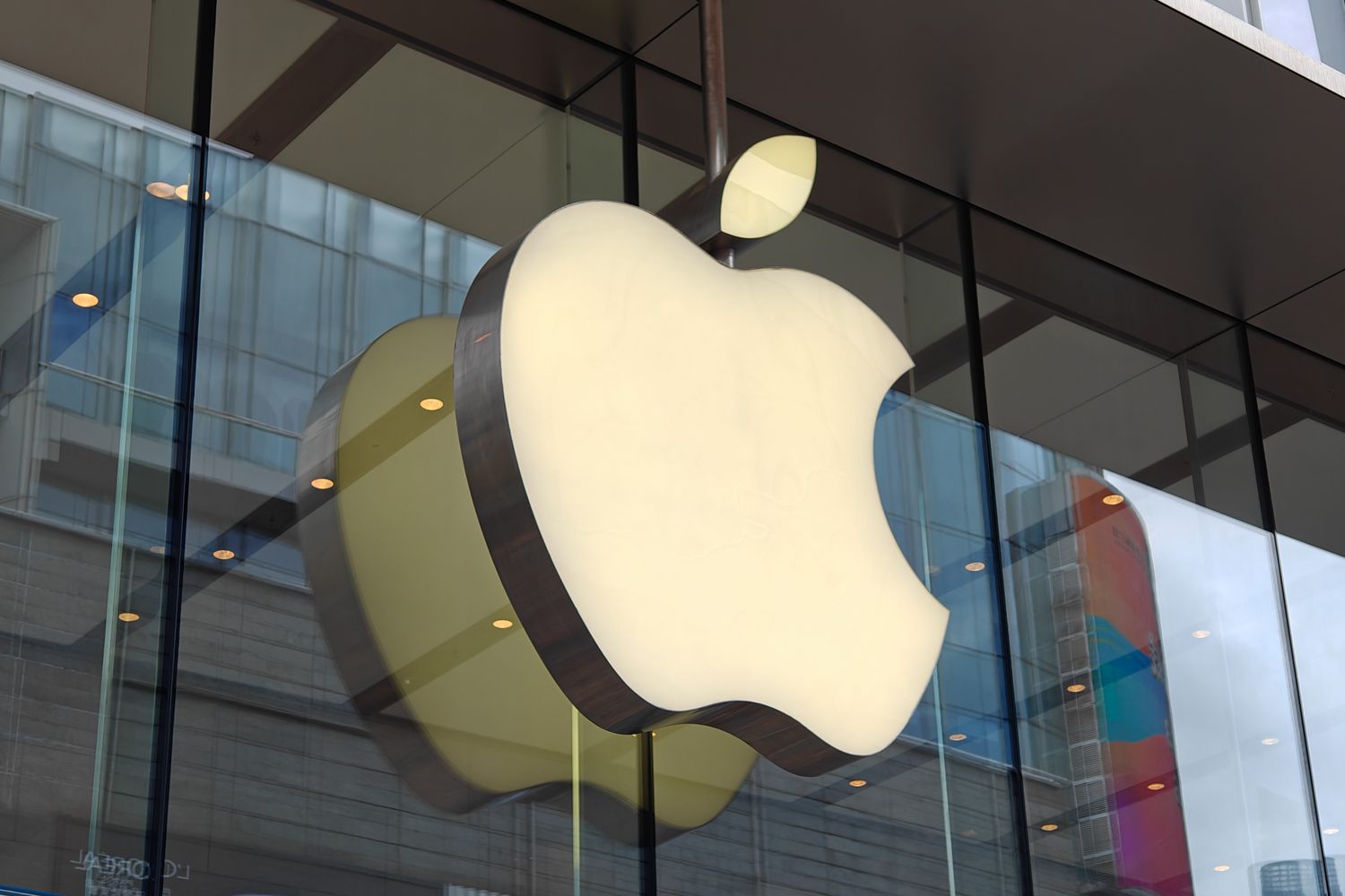 The Apple logo glows outside of a Shanghai store.