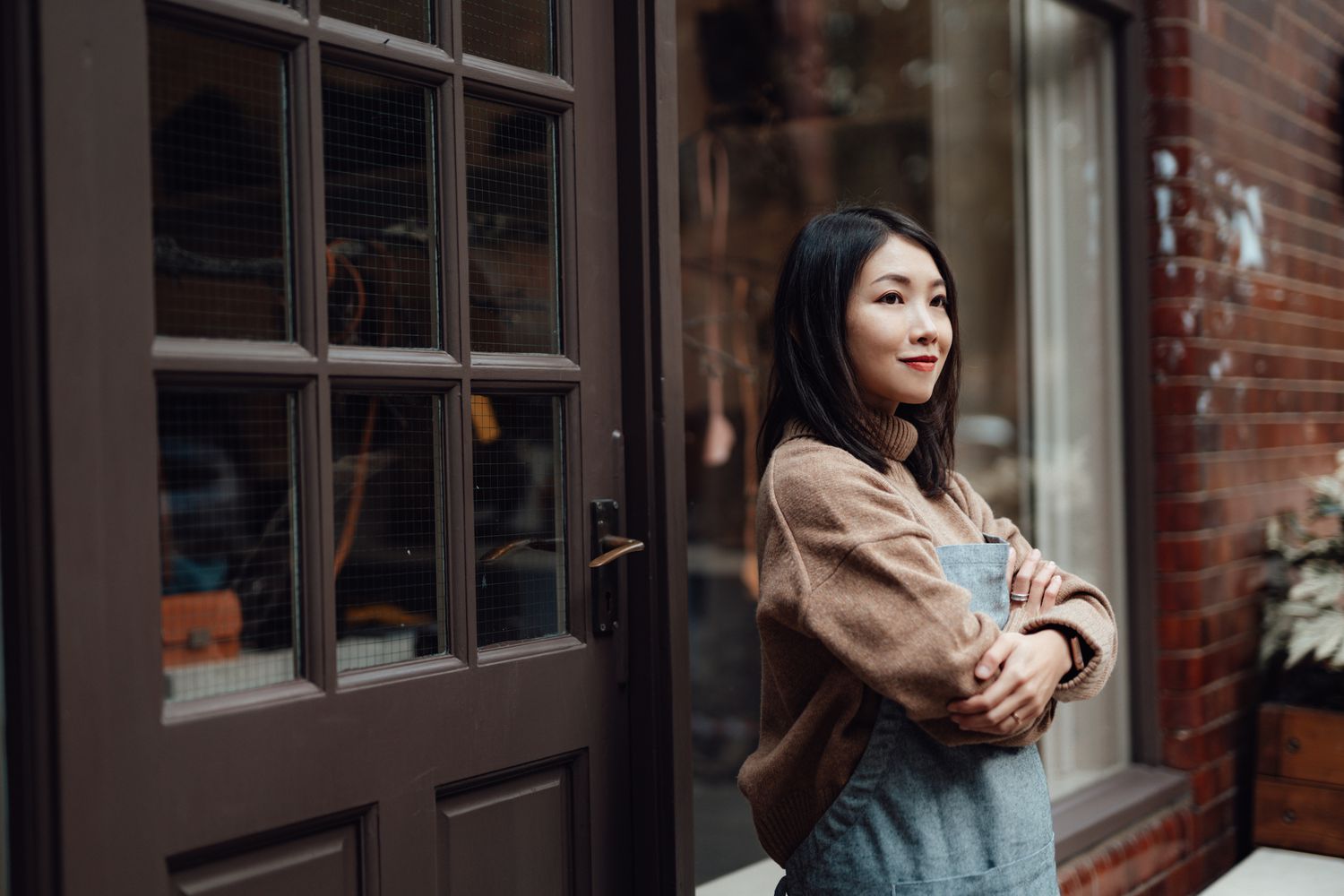 Young woman stands in front of her retail shop