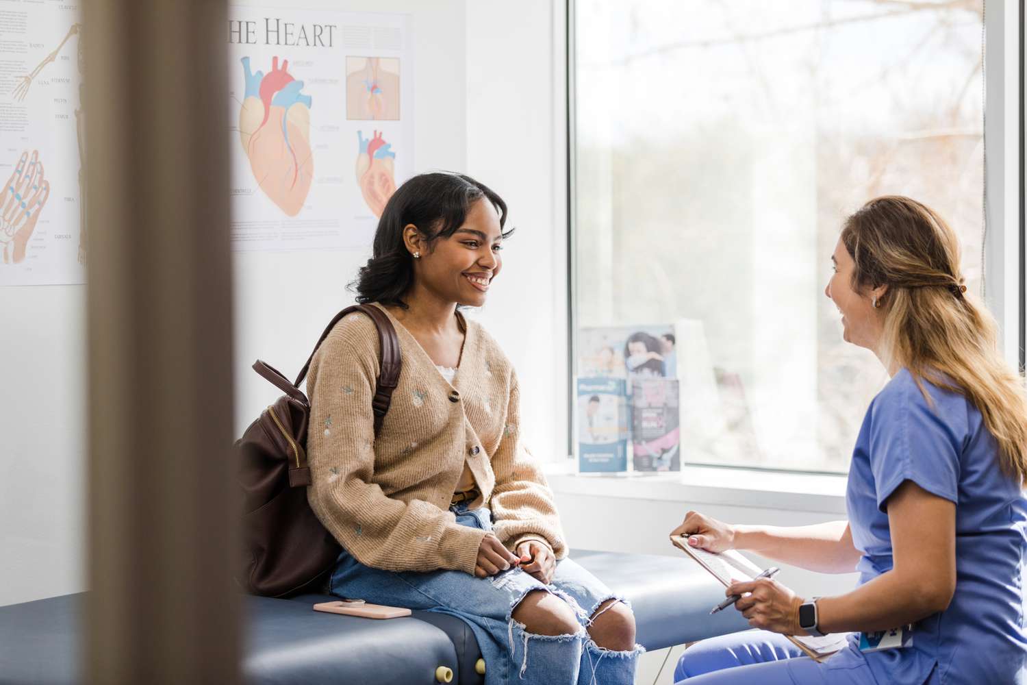 Young female student talking to nurse