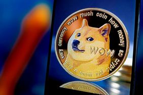 An image of a Dogecoin is seen on a screen in front of a blue and orange background.