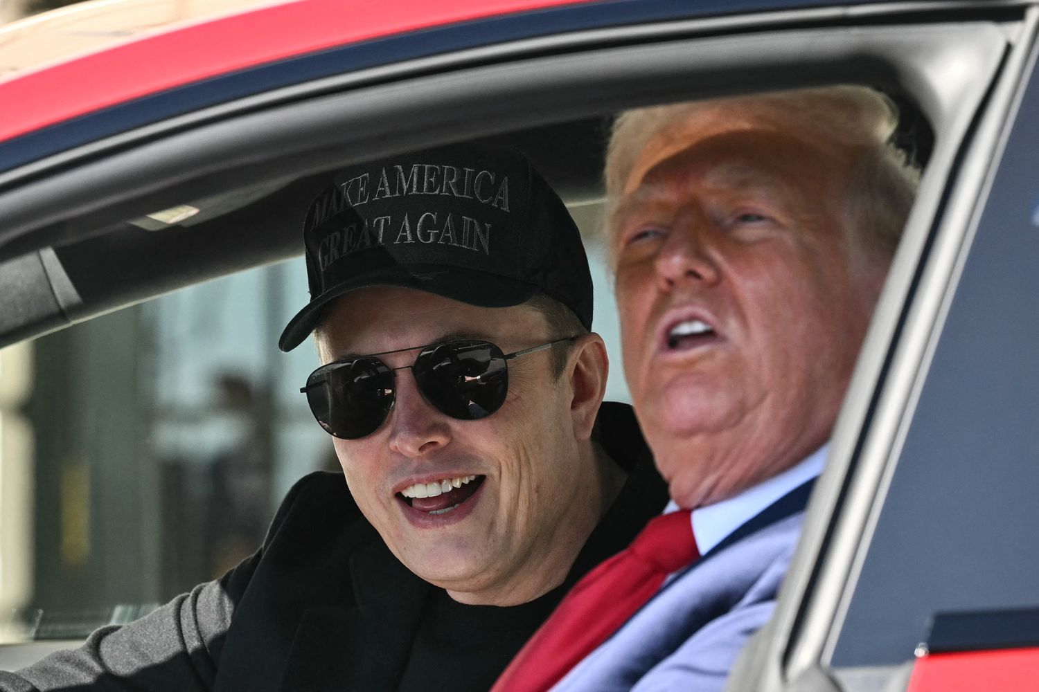 US President Donald Trump and Tesla CEO Elon Musk speak to the press as they sit in a Tesla vehicle on the South Portico of the White House on March 11, 2025 in Washington, DC.