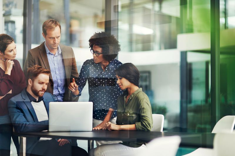 A group of colleagues discussing the difference between Experience and Equifax.