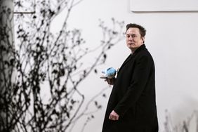 Elon Musk holding a stuffed Air Force One