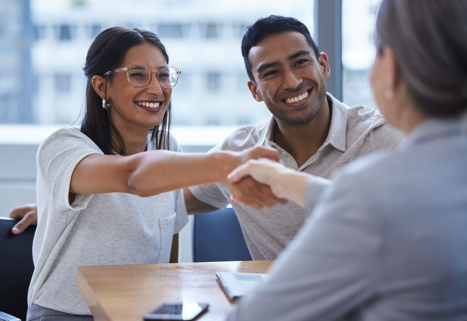 Couple shakes hands with a banker