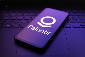 The Palantir Technologies logo appears on the screen of a smartphone