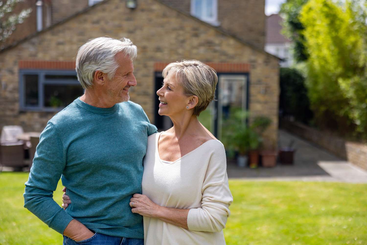 Older couple in front of a house