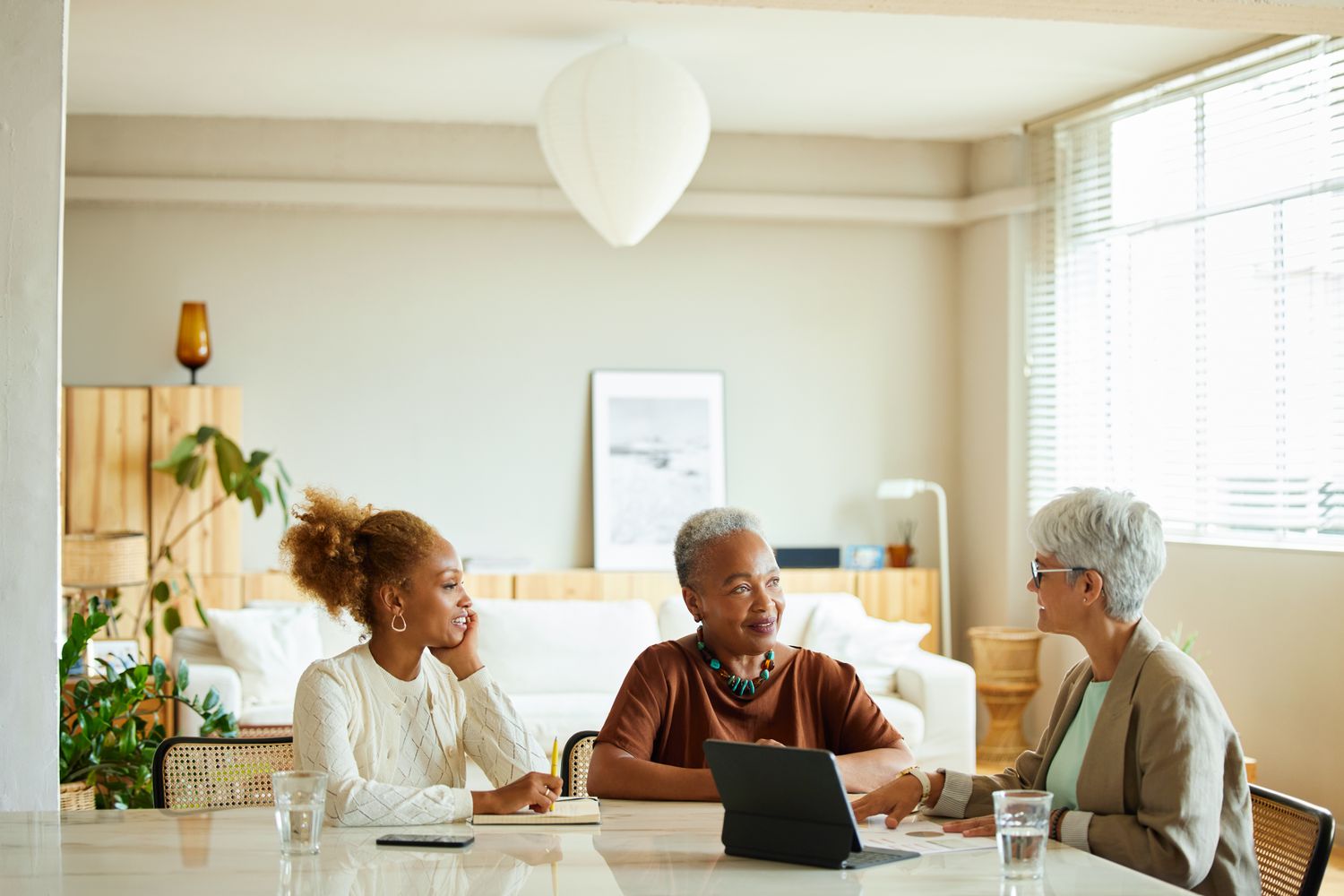 Two women sitting around a table talking to a financial advisor.