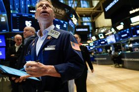Traders work on the floor of the New York Stock Exchange (NYSE)