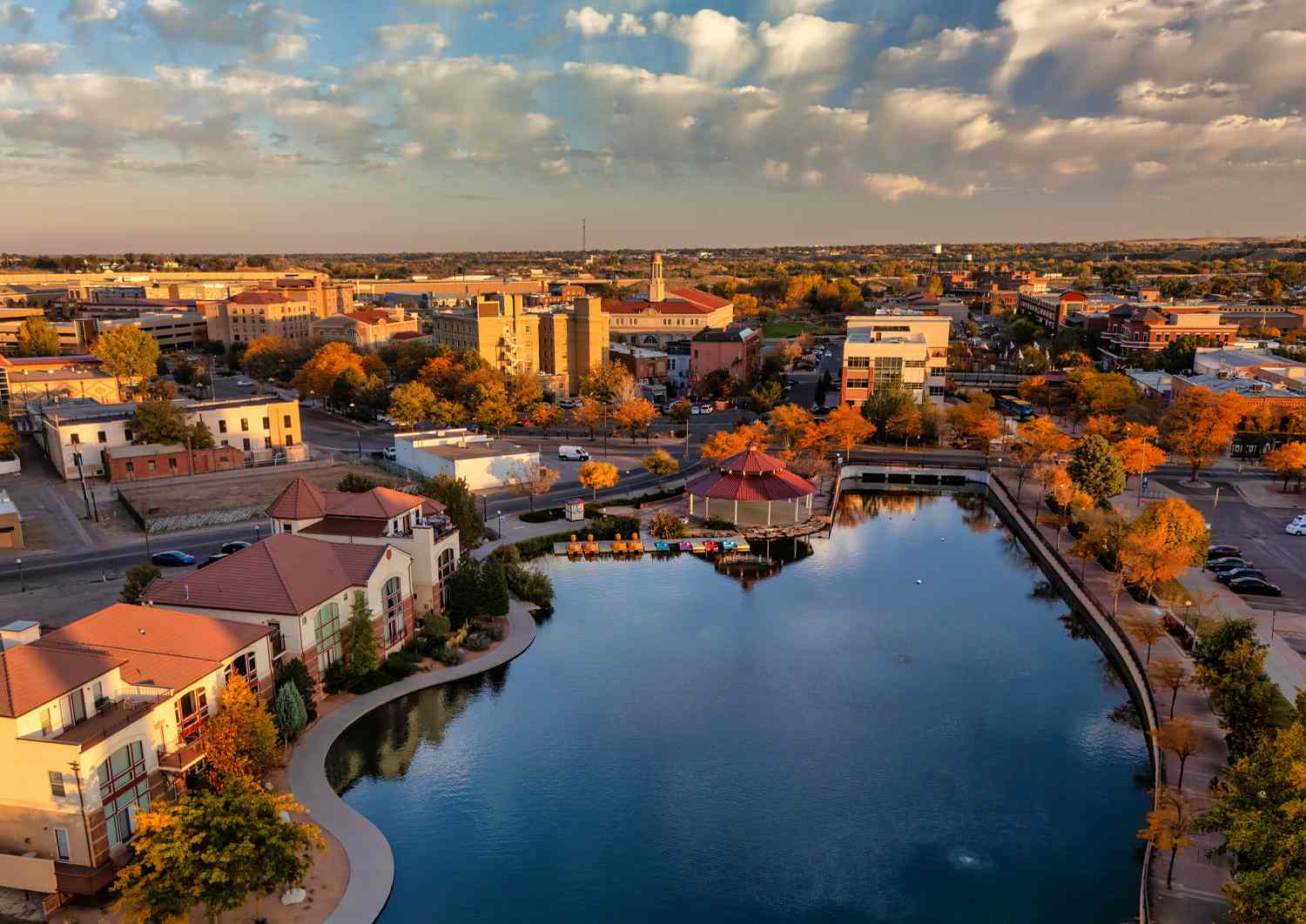 Aerial of Downtown Pueblo, Colorado during autumn with a lake in the foreground.