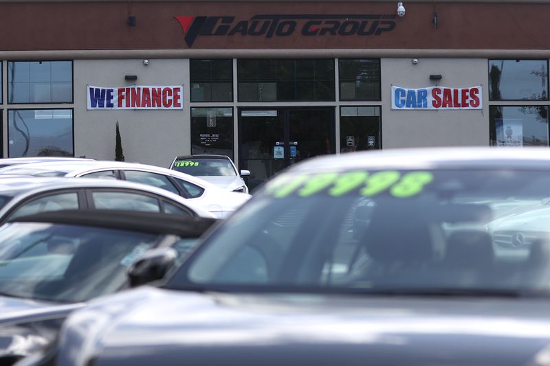 A "We Finance" sign is posted at an auto dealership in California. 