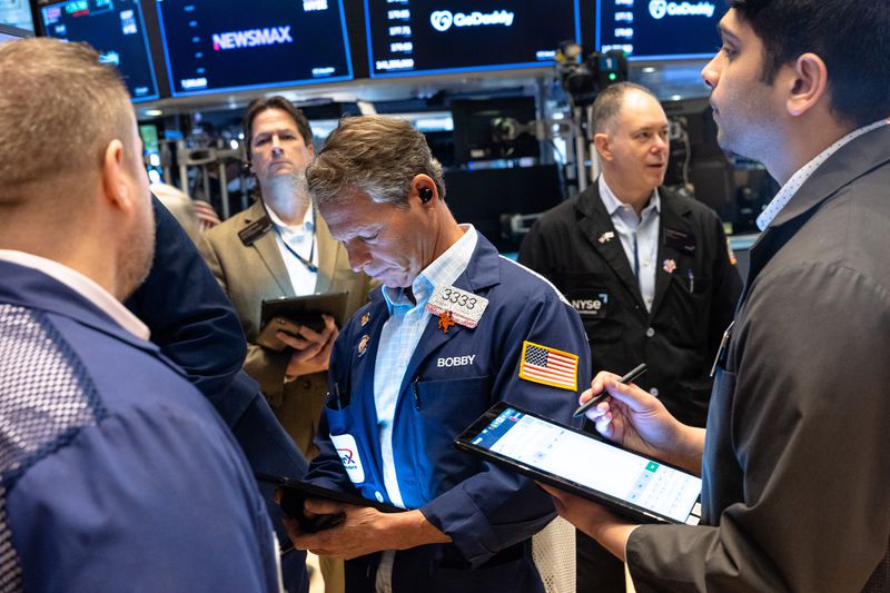 Traders work on the floor of the New York Stock Exchange during morning trading on April 01, 2025 in New York City. 