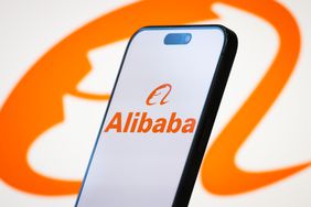The logo of Alibaba Group Holding Limited is displayed on a smartphone screen, with the company's distinctive orange branding in the background