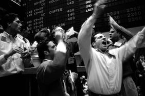 A group of floor traders gester and shout during trading on the floor of the Coffee, Sugar, and Cocoa Exchange in New York City.