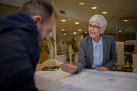 An institutional banker sits across a table to negotiate the price the bank would be willing to sell securities back to the broker-dealer.