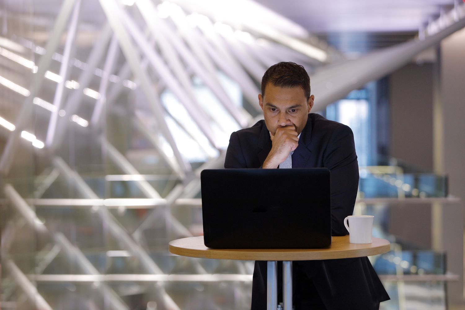 Concerned businessman looking at a laptop