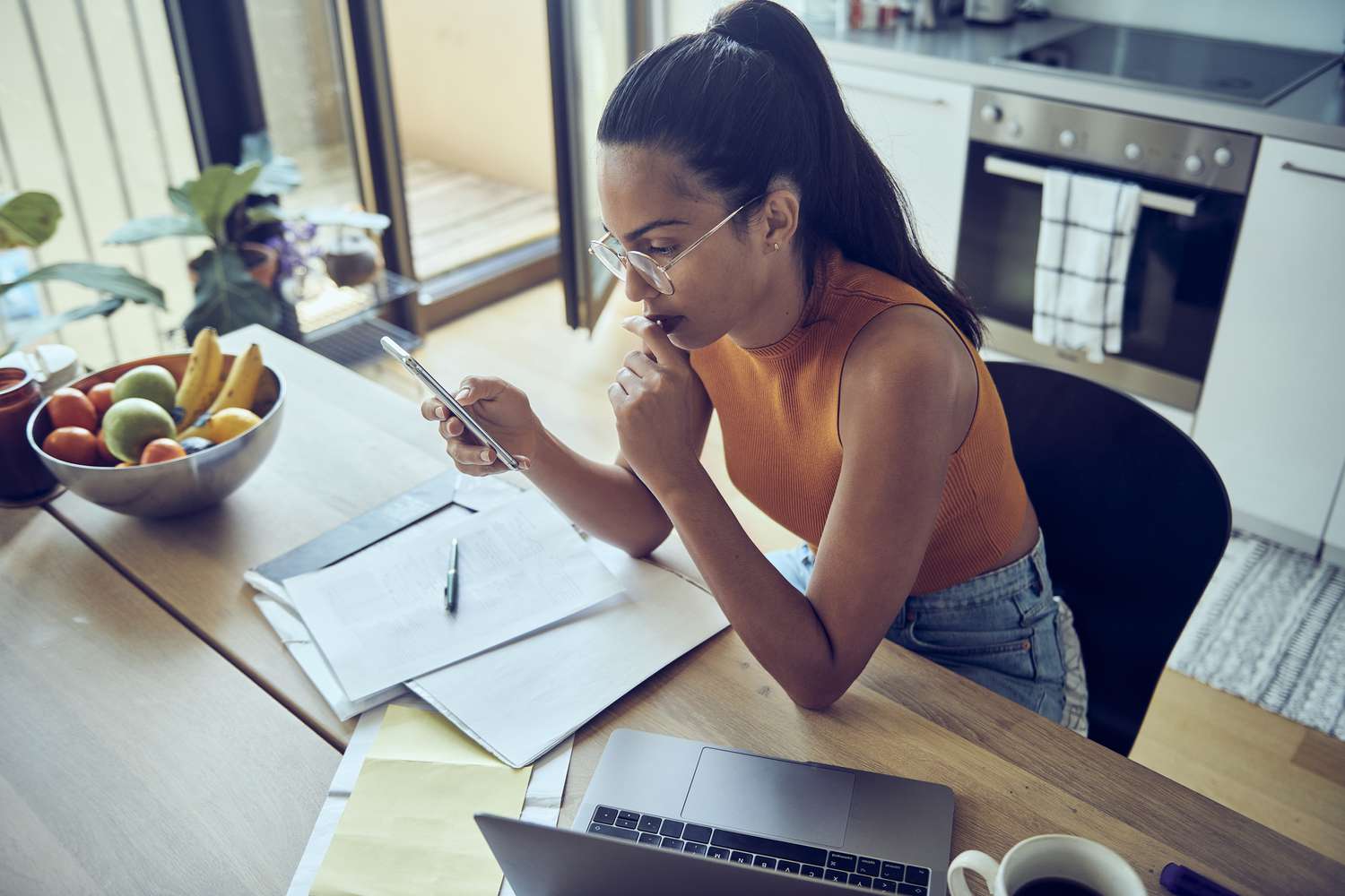 A woman researches investments on her smartphone to decide if European EFTs are right for her portfolio