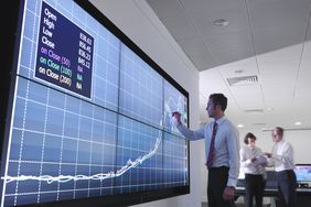 A person uses a screen pen to mark on a large screen.